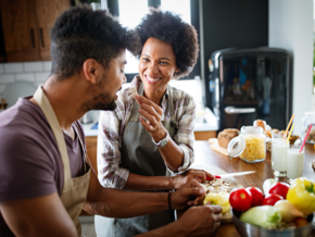 woman and man eating in the kitchen woman and man eating in the kitchen
