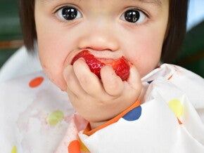 Baby eating whole strawberry baby-led weaning Baby eating whole strawberry baby-led weaning