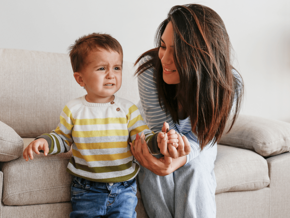 mom holding  toddler hand