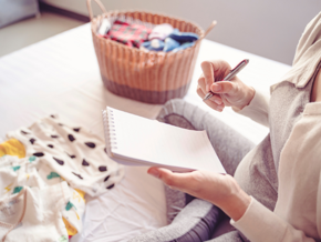 Pregnant woman writing on a notepad