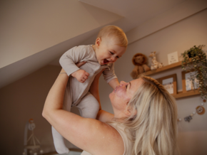 Mother holding baby in the air Mother holding baby in the air