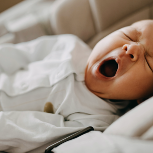 Building a Calm Infant Sleep Routine a baby yawning