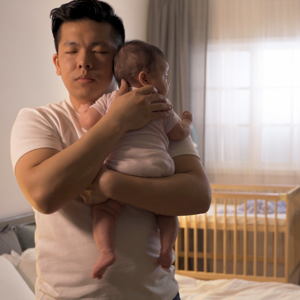 When Do Infants Sleep Through the Night dad making baby sleep